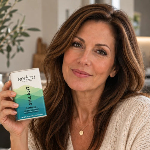 Woman holding a tin of Endura Shilajit Gummies