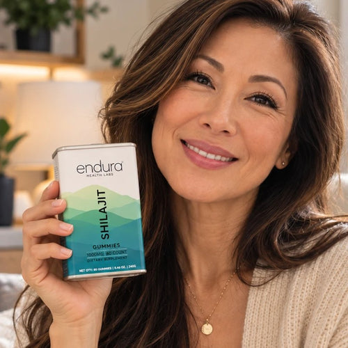 Woman smiling with a tin of Endura Shilajit Gummies