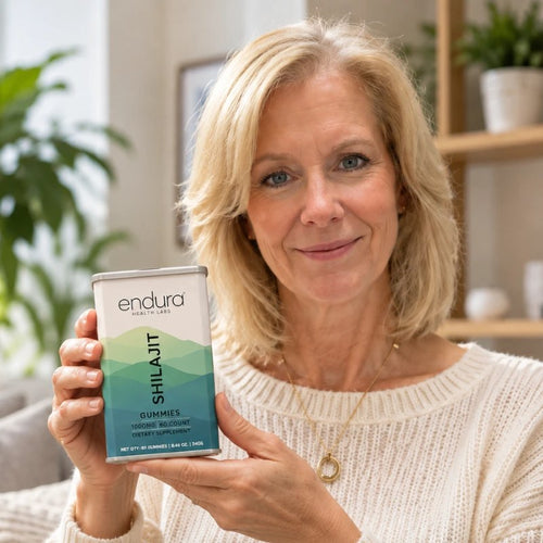 Woman showing a tin of Endura Shilajit Gummies